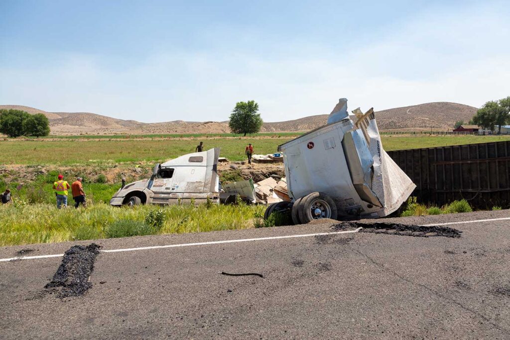 Tractor trailer accident on the side of the road.