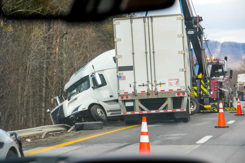 Tractor trailer accident on the side of the road.