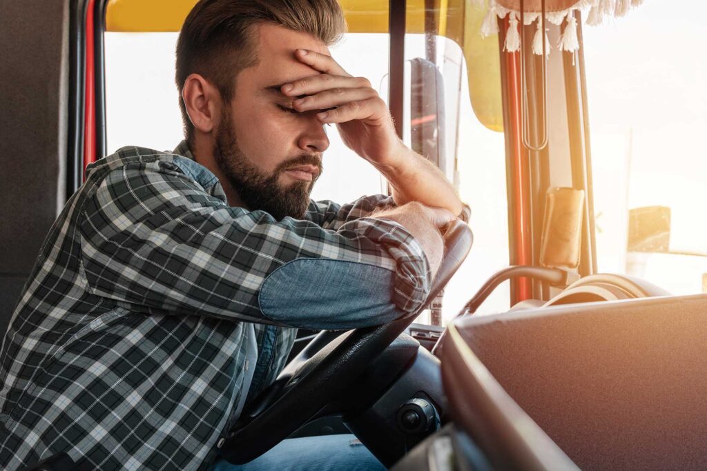 Stressed truck driver needing a trucking accident lawyer.