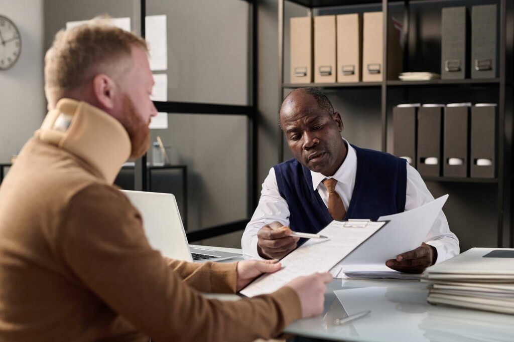 Injured man in Georgia meeting with a personal injury attorney.